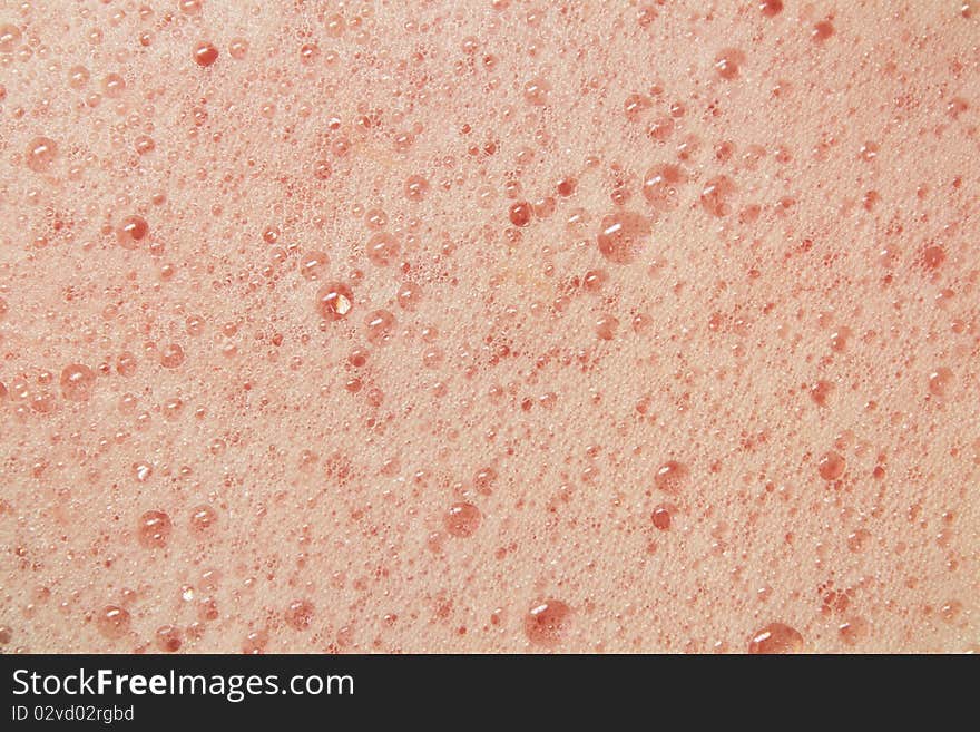 Close up of grapefruit juice bubbles fresh out of a blender.