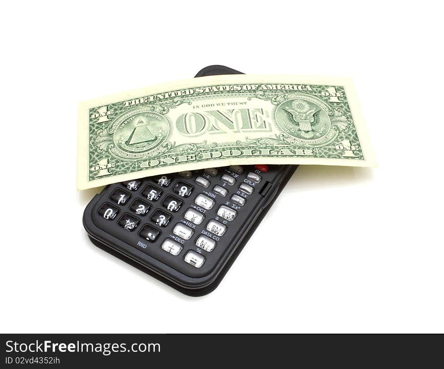 The black calculator on a white background and on it lies one dollar a denomination. The black calculator on a white background and on it lies one dollar a denomination