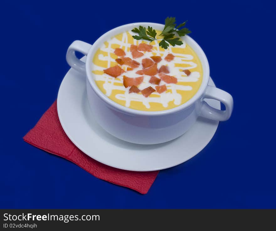 Soup photo in a bowl on a blue background. Soup photo in a bowl on a blue background