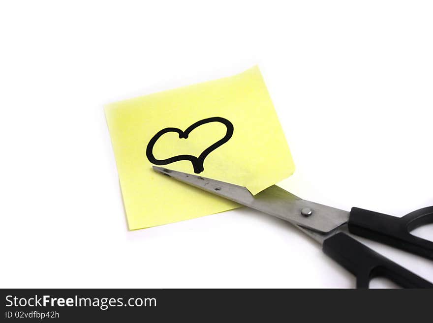 We see the scissors cutting note with heart on white background