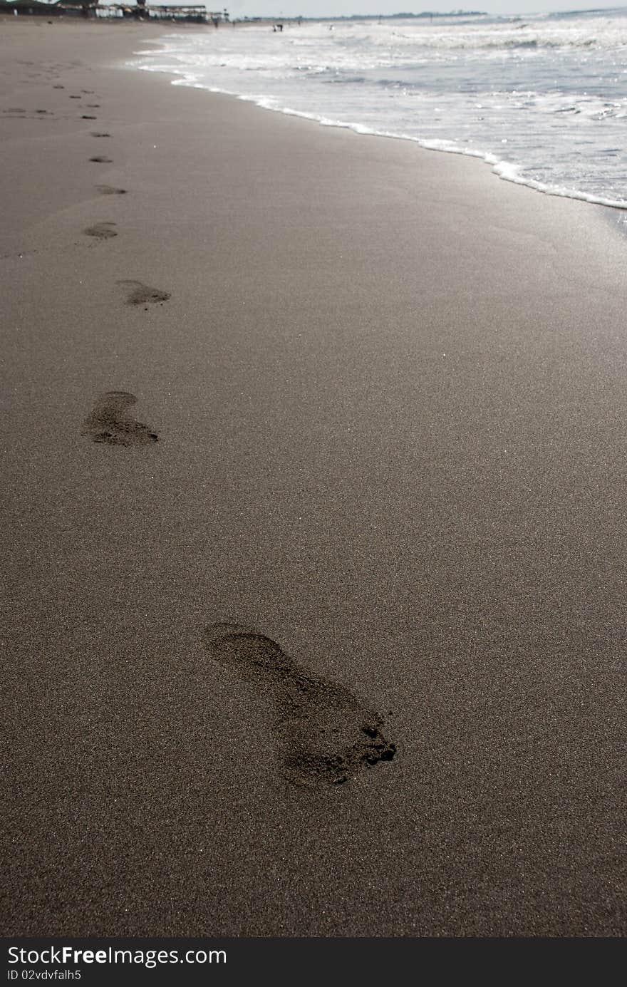 Alone human steps on the sand beach. Alone human steps on the sand beach