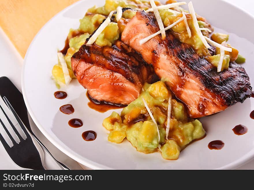 Salmon with mashed avocado and mango