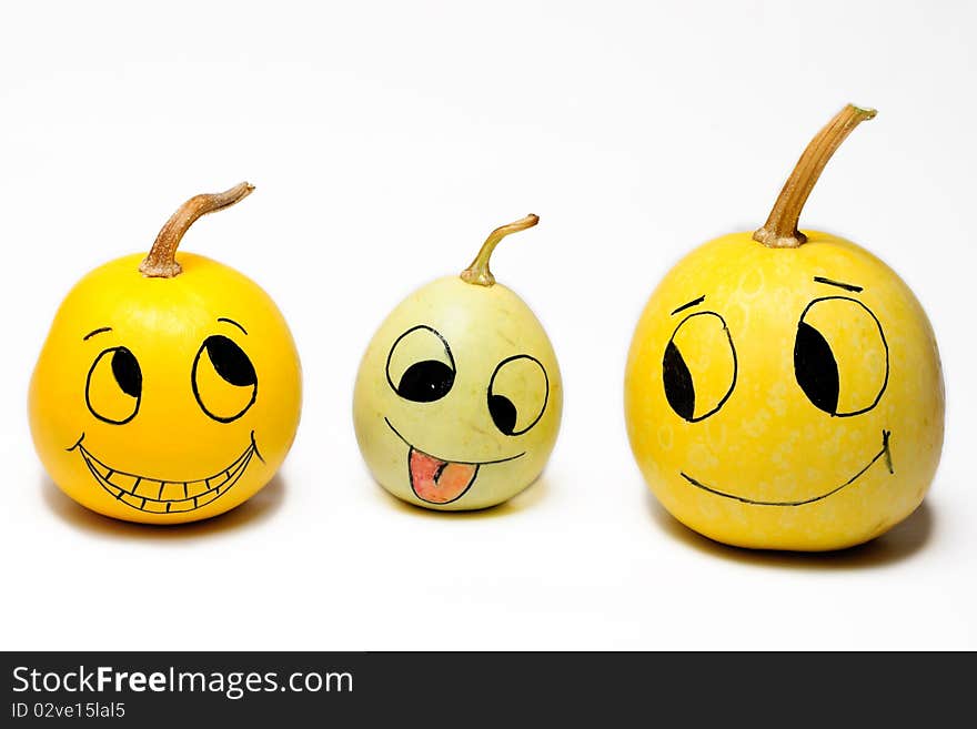 Decorative pumpkins with faces drawn on them. Decorative pumpkins with faces drawn on them