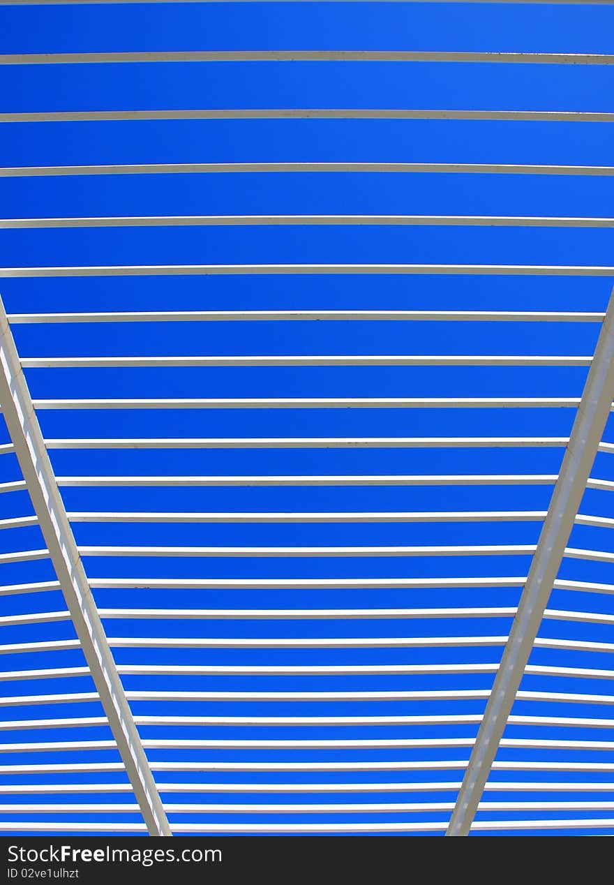 Modern roof architecture with white steel and blue sky in the background