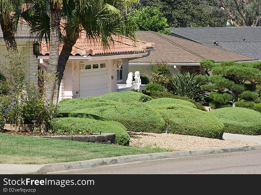 Neatly landscaped front yard of a house. Neatly landscaped front yard of a house.