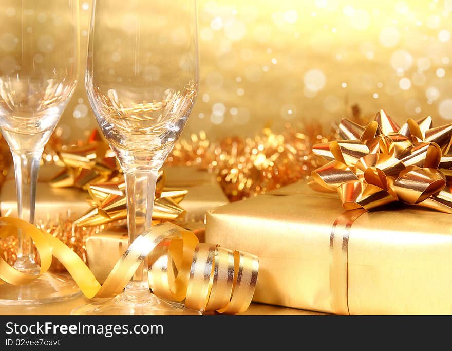 Studio photo of empty champagne glasses and golden decoration on background. Studio photo of empty champagne glasses and golden decoration on background