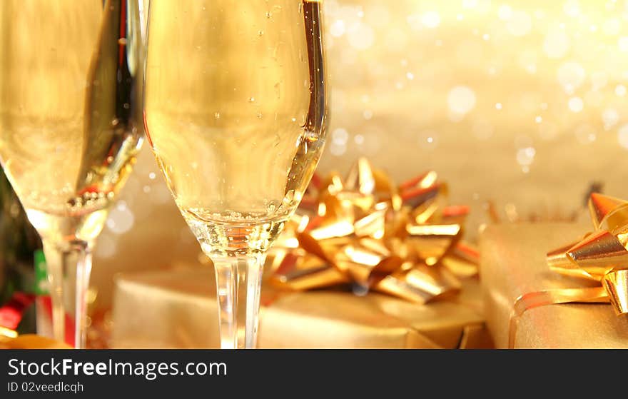 Studio photo of champagne glasses and golden decoration on background. Studio photo of champagne glasses and golden decoration on background