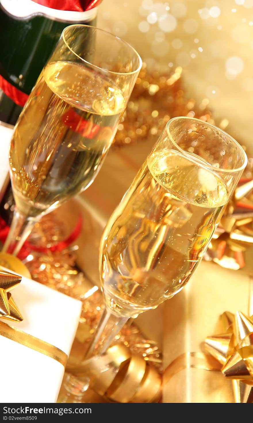 Studio photo of champagne glasses and golden decoration on background. Studio photo of champagne glasses and golden decoration on background