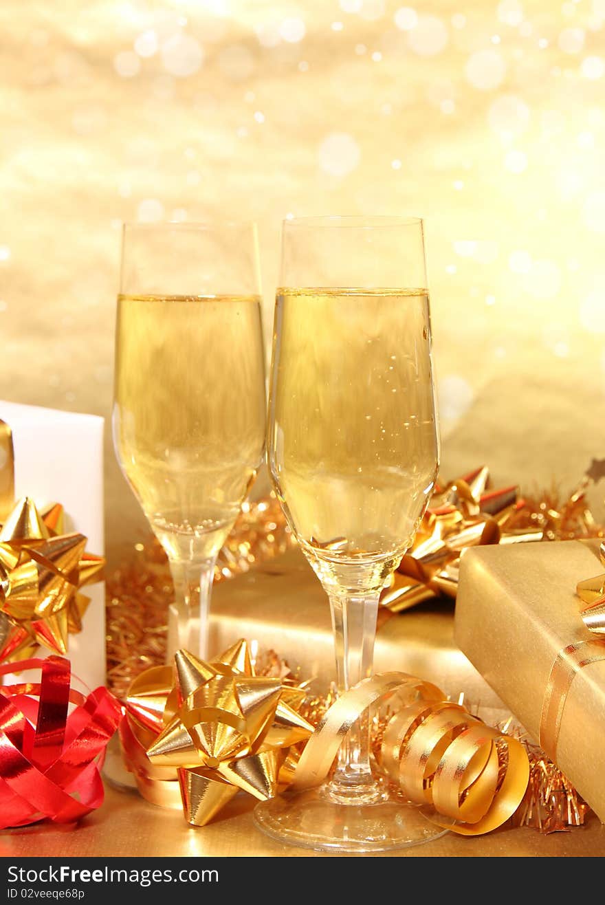 Studio photo of champagne glasses and golden decoration on background. Studio photo of champagne glasses and golden decoration on background