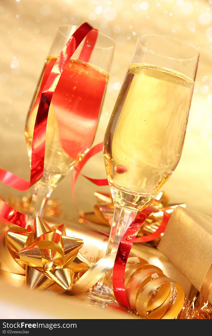 Studio photo of champagne glasses and golden decoration on background. Studio photo of champagne glasses and golden decoration on background