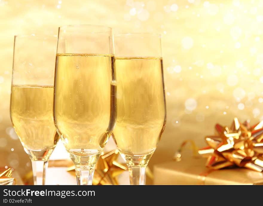 Studio photo of champagne glasses and golden decoration on background. Studio photo of champagne glasses and golden decoration on background