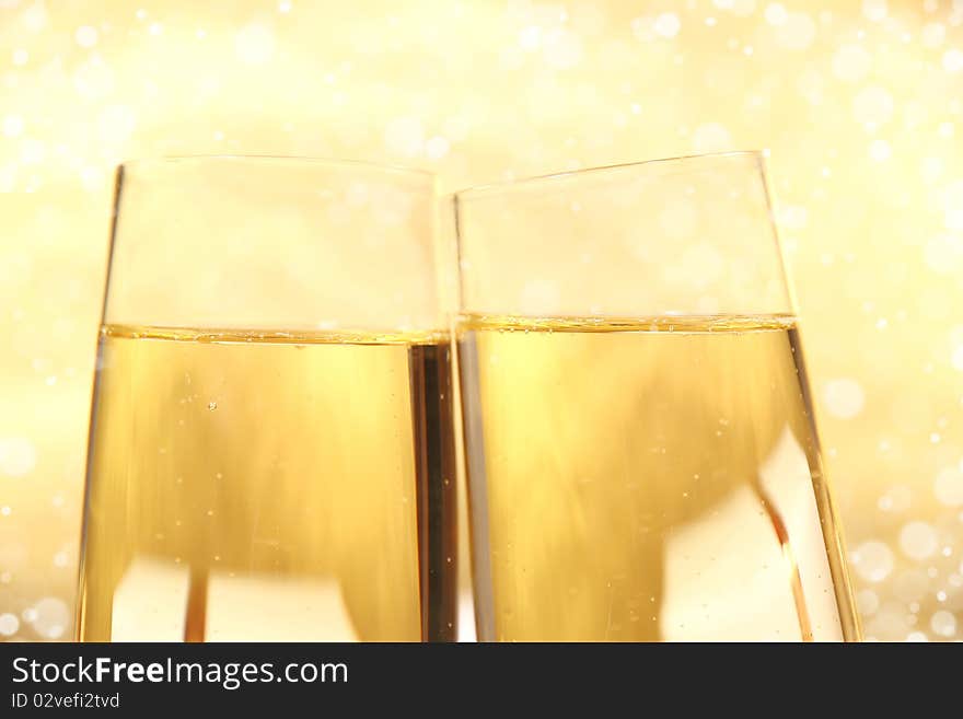 Studio photo of champagne glasses on gold background. Studio photo of champagne glasses on gold background