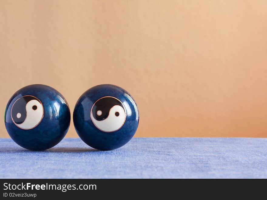 Two chineese yin-yang  balls on a table. Two chineese yin-yang  balls on a table