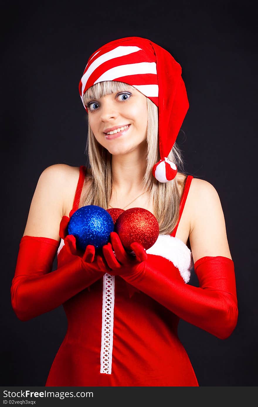 Santa girl holding a Christmas ball, Christmas toys.Holidays New Year and Christmas