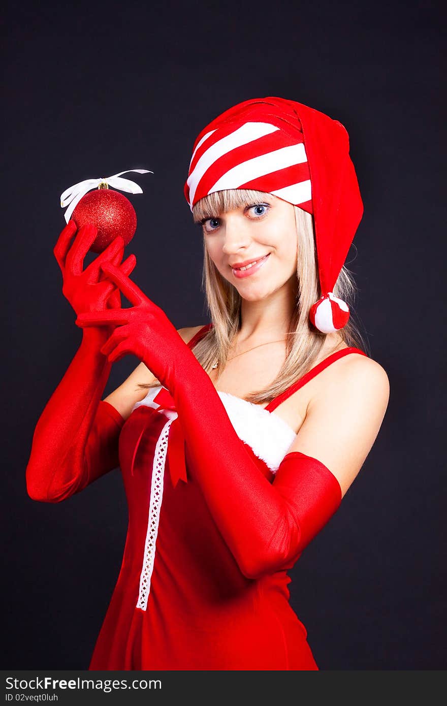 Santa girl holding a Christmas ball, Christmas toys.Holidays New Year and Christmas