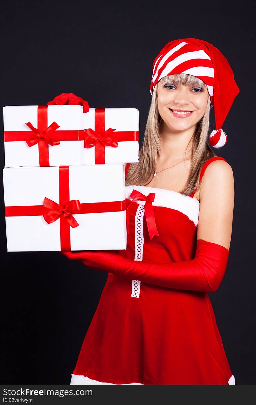 Santa girl holding the box with gifts. Holidays New Year and Christmas