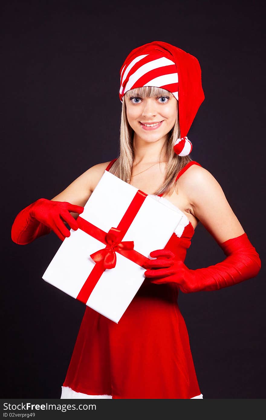 Santa girl holding the box with gifts.