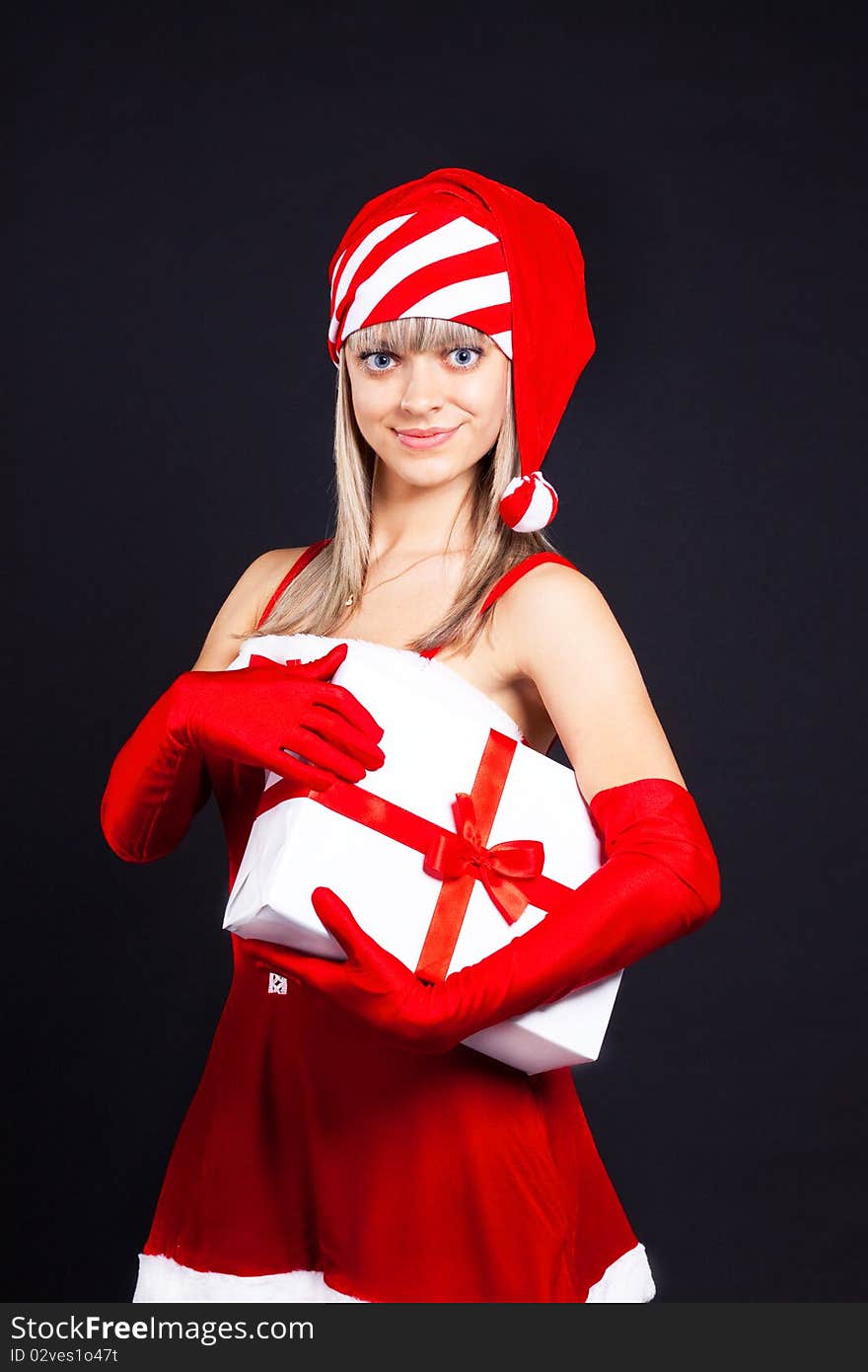 Santa Girl Holding The Box With Gifts.