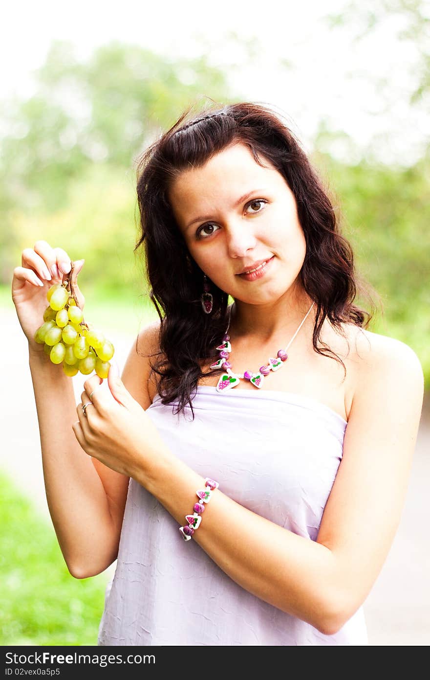 Beautiful girl in the fashion jewelry hair raises her hand