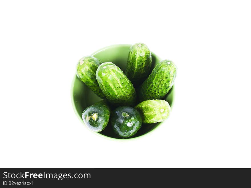 green wet cucumbers in green bowl