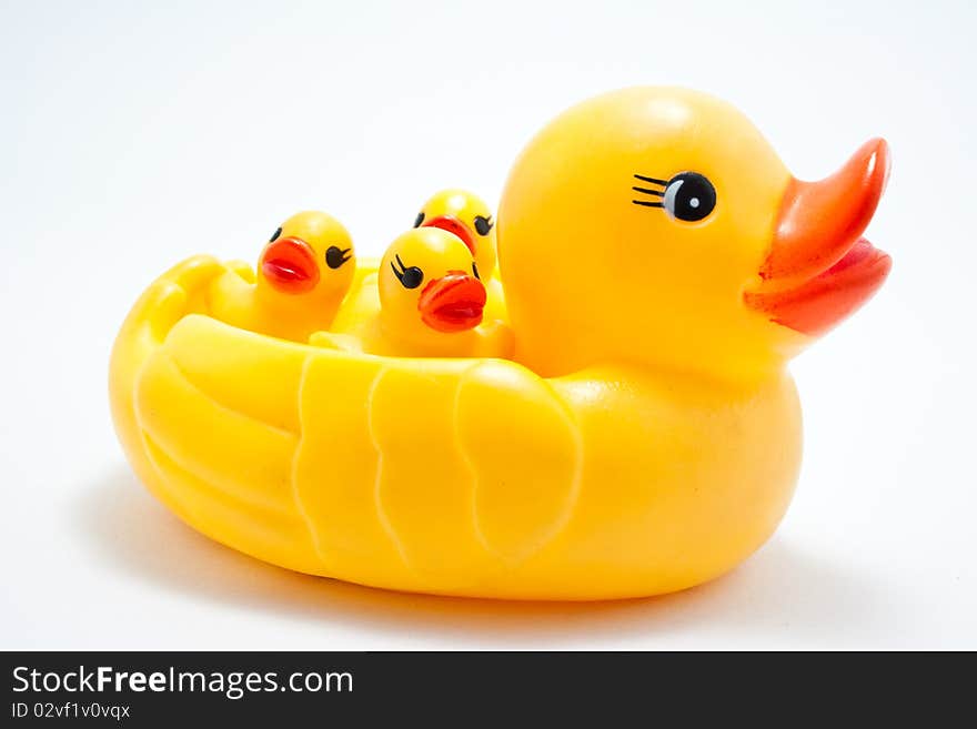 Plastic yellow duck toy on white background