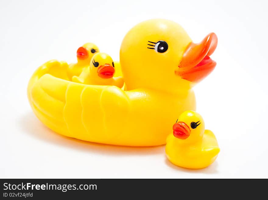 Plastic yellow duck toy on white background