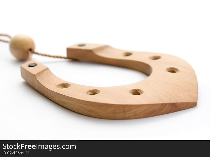 Wooden horseshoe souvenir on a thread isolated on white background