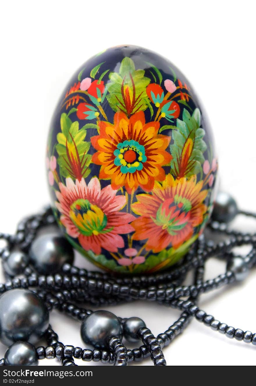 Ukrainian handmade painted Easter eggs witn string of beads on white