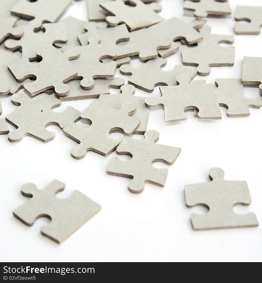 Pieces of puzzle upturned on white background