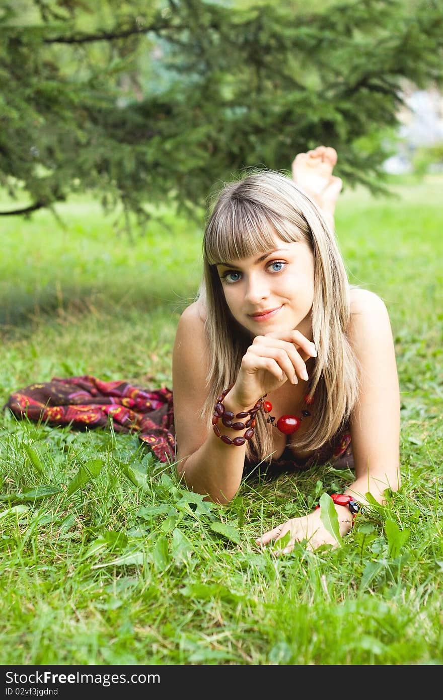 Girl Lying On The Grass And Smiling