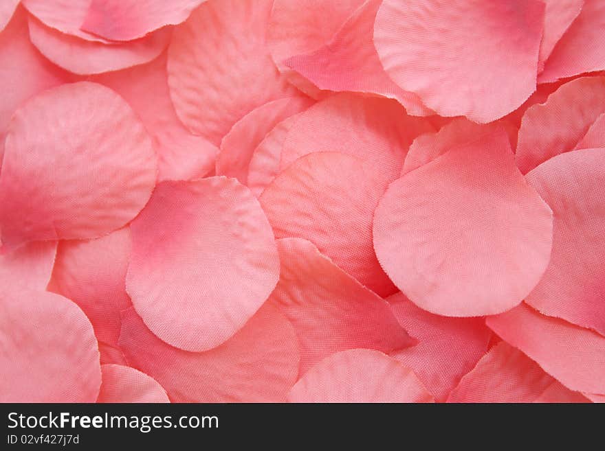 Pink artificial rose petals background