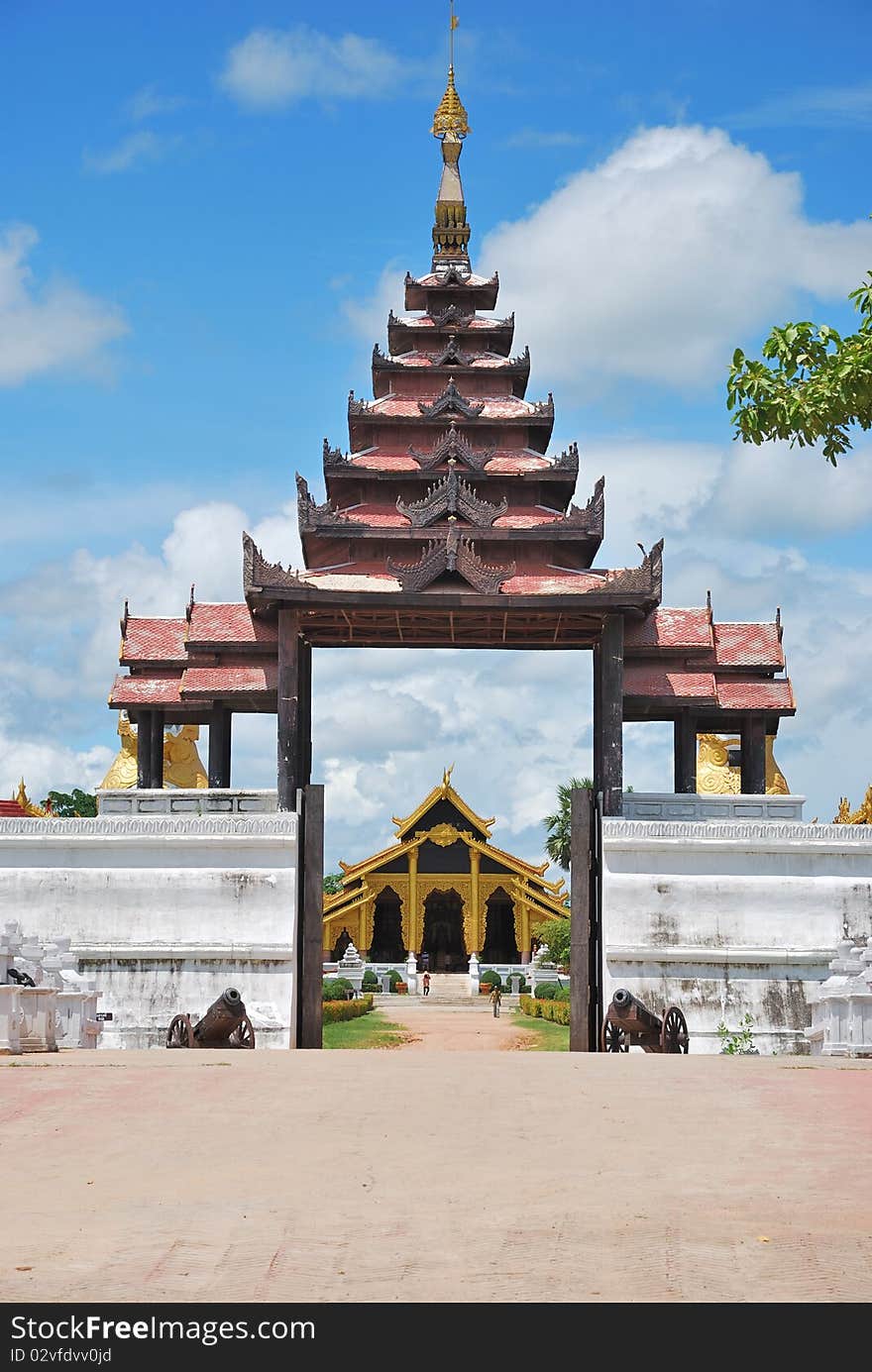 Arched entrance of buddhist temple with brighten sky