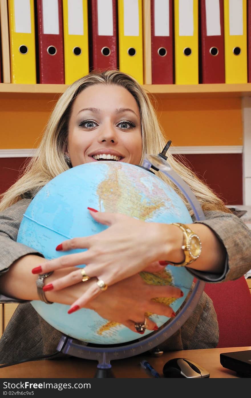 Business woman and globe in the office