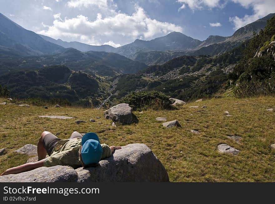 Young Woman relaxing in the Pirin mountains in Bulgaria. Young Woman relaxing in the Pirin mountains in Bulgaria