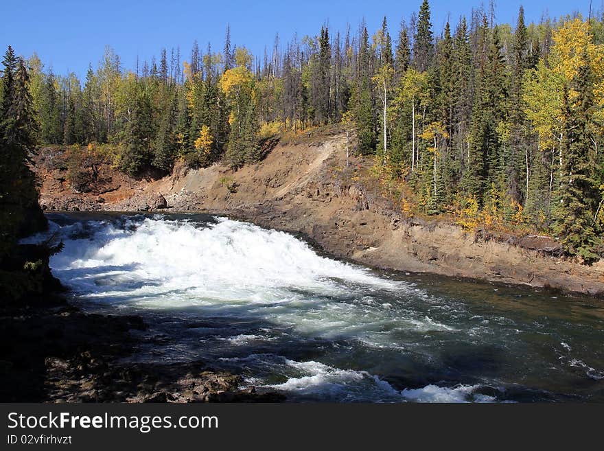 Autumn starts ate Cheslatta Falls, British Columbia, Canada