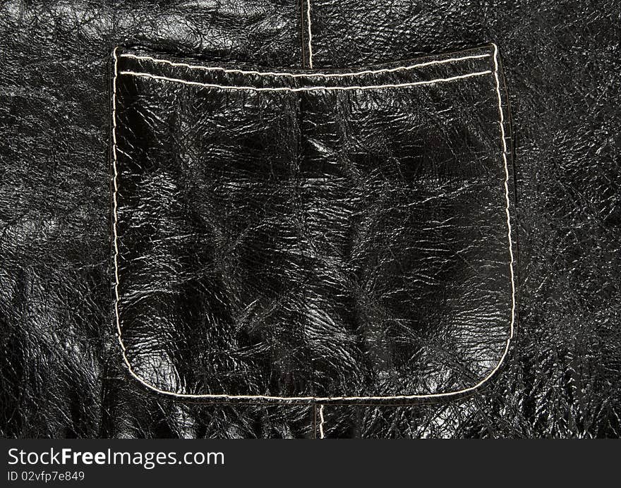 Stitched pocket on shiny black leather clothing showing detailed texture. Stitched pocket on shiny black leather clothing showing detailed texture.