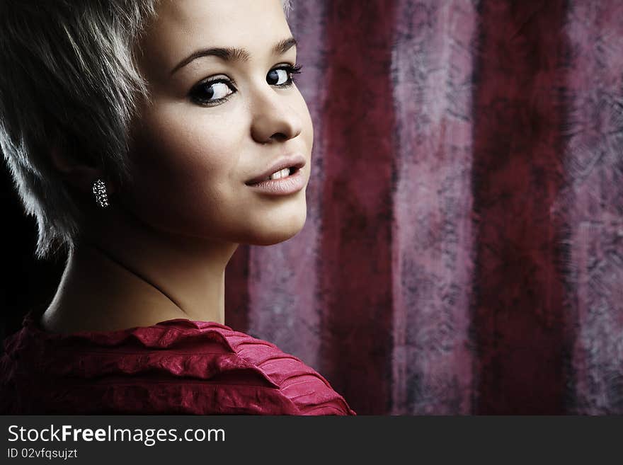 Beautiful attractive girl in pink dress on pink background