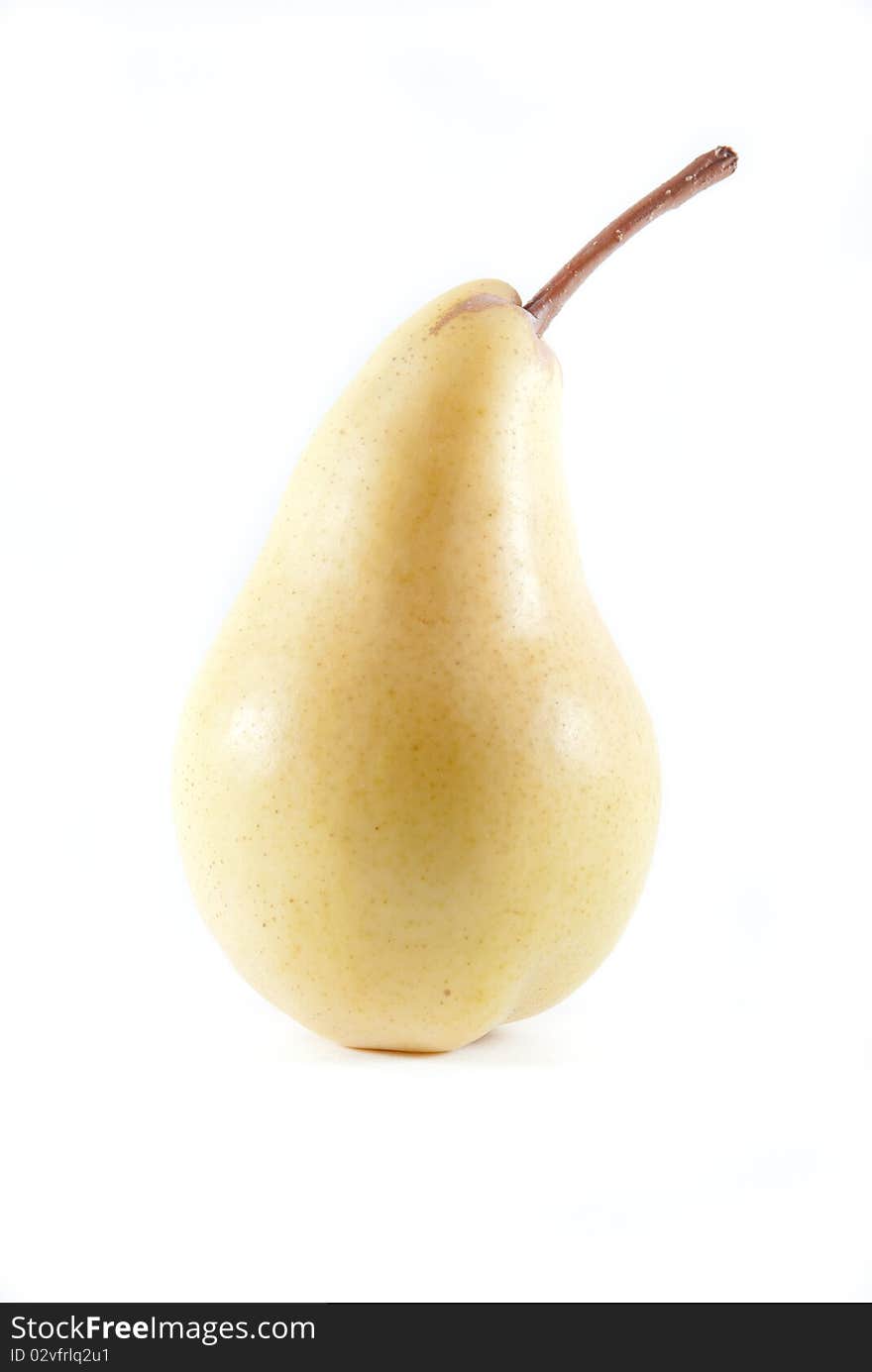 One yellow ripe pear with stem on a white isolated background. One yellow ripe pear with stem on a white isolated background