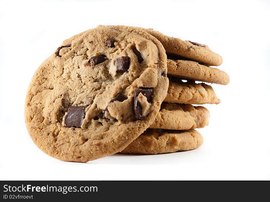 Upright cookies against a stack of chocolate chip cookies on a white isolated background. Upright cookies against a stack of chocolate chip cookies on a white isolated background