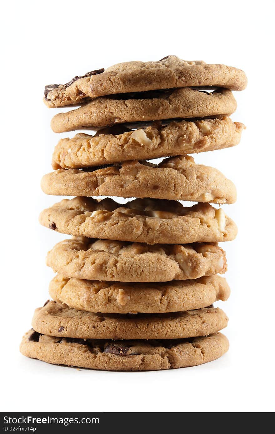 Tall stack of mixed chocolate chip and macadamia nut cookies on a white isolated background. Tall stack of mixed chocolate chip and macadamia nut cookies on a white isolated background.