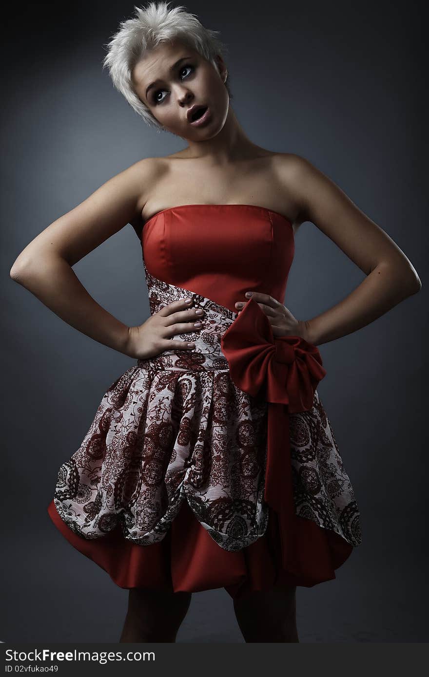 Beautiful model dressed as fashion fairy posing on black background