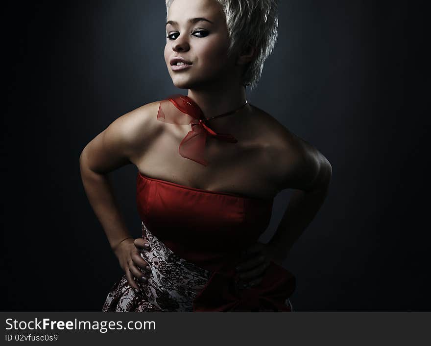 Beautiful model dressed as fashion fairy posing on black background