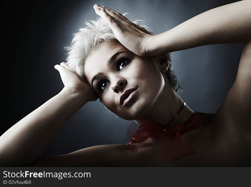 Beautiful model dressed as fashion fairy posing on black background