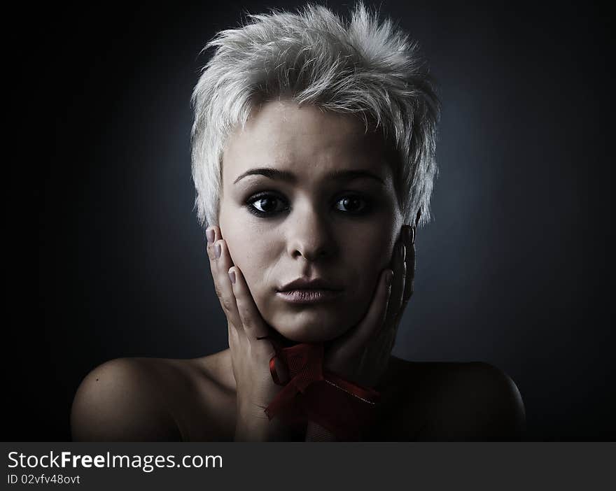 Beautiful model dressed as fashion fairy posing on black background