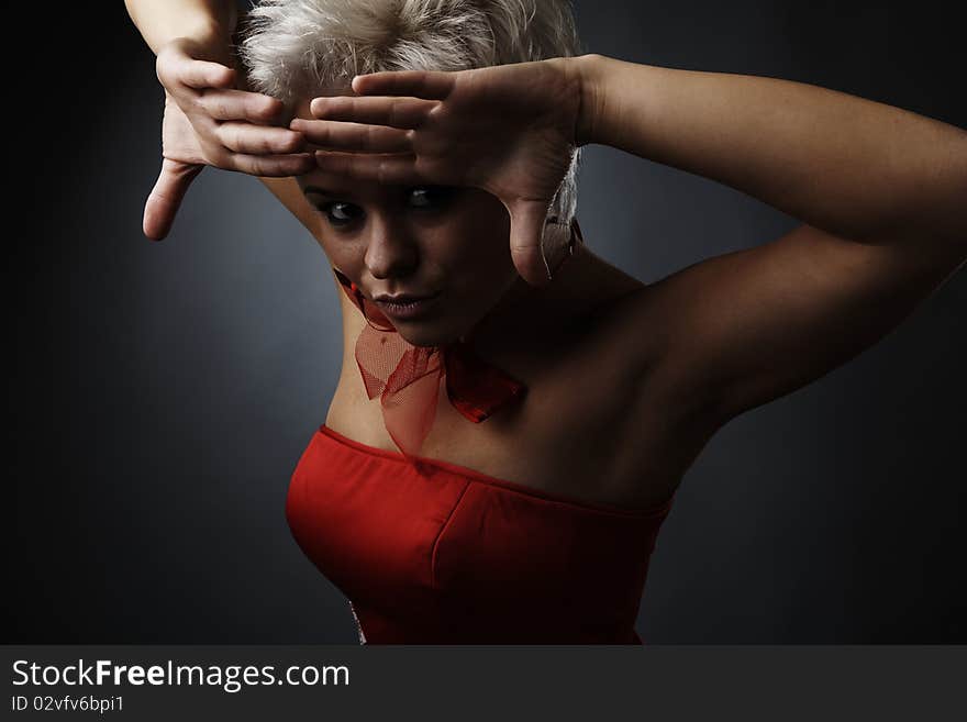 Beautiful model dressed as fashion fairy posing on black background