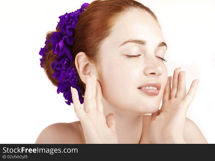 The image of a beautiful girl with flowers in her hair