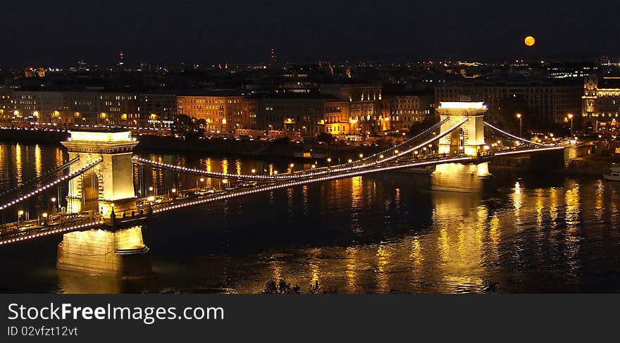 Shooting from the Buda Castle it was great fun to have a full moon come up the same color as many of the lights of the city.  The Chain Bridge connects the Buda and Pest sides of the city of Budapest and crosses the Danube River. Shooting from the Buda Castle it was great fun to have a full moon come up the same color as many of the lights of the city.  The Chain Bridge connects the Buda and Pest sides of the city of Budapest and crosses the Danube River.