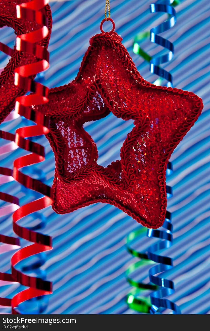 Red christmas star and ribbons on blue stripe background. Red christmas star and ribbons on blue stripe background