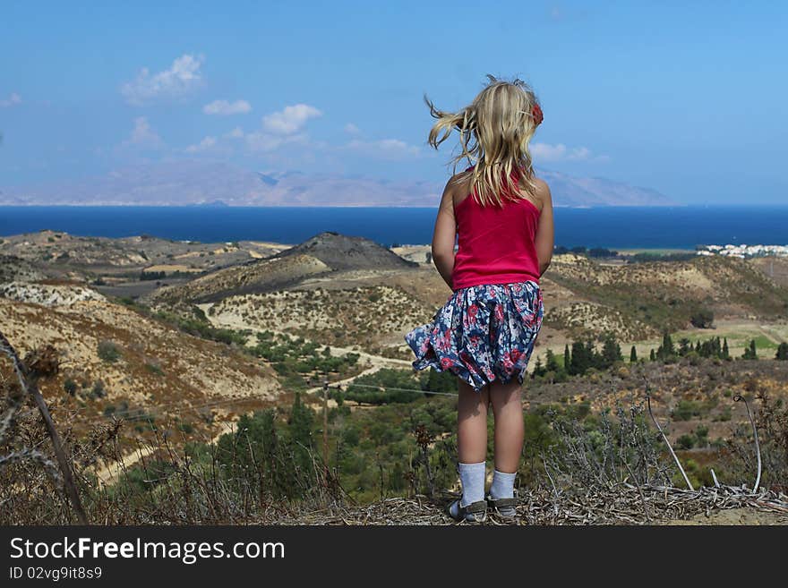 Girl looks at the beautiful sea, beach and mountains in Greece. Girl looks at the beautiful sea, beach and mountains in Greece