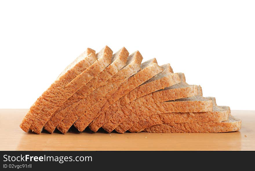 Pile up wheat bread on the wooden table. Pile up wheat bread on the wooden table